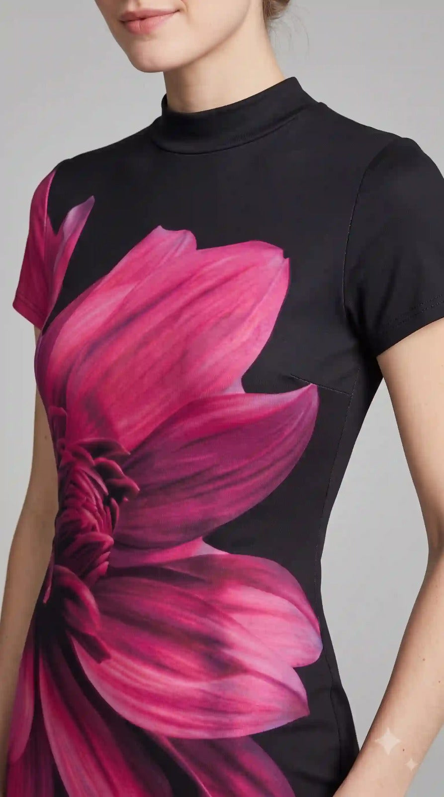 Close-up of pink floral print and mock neck on black bodycon dress