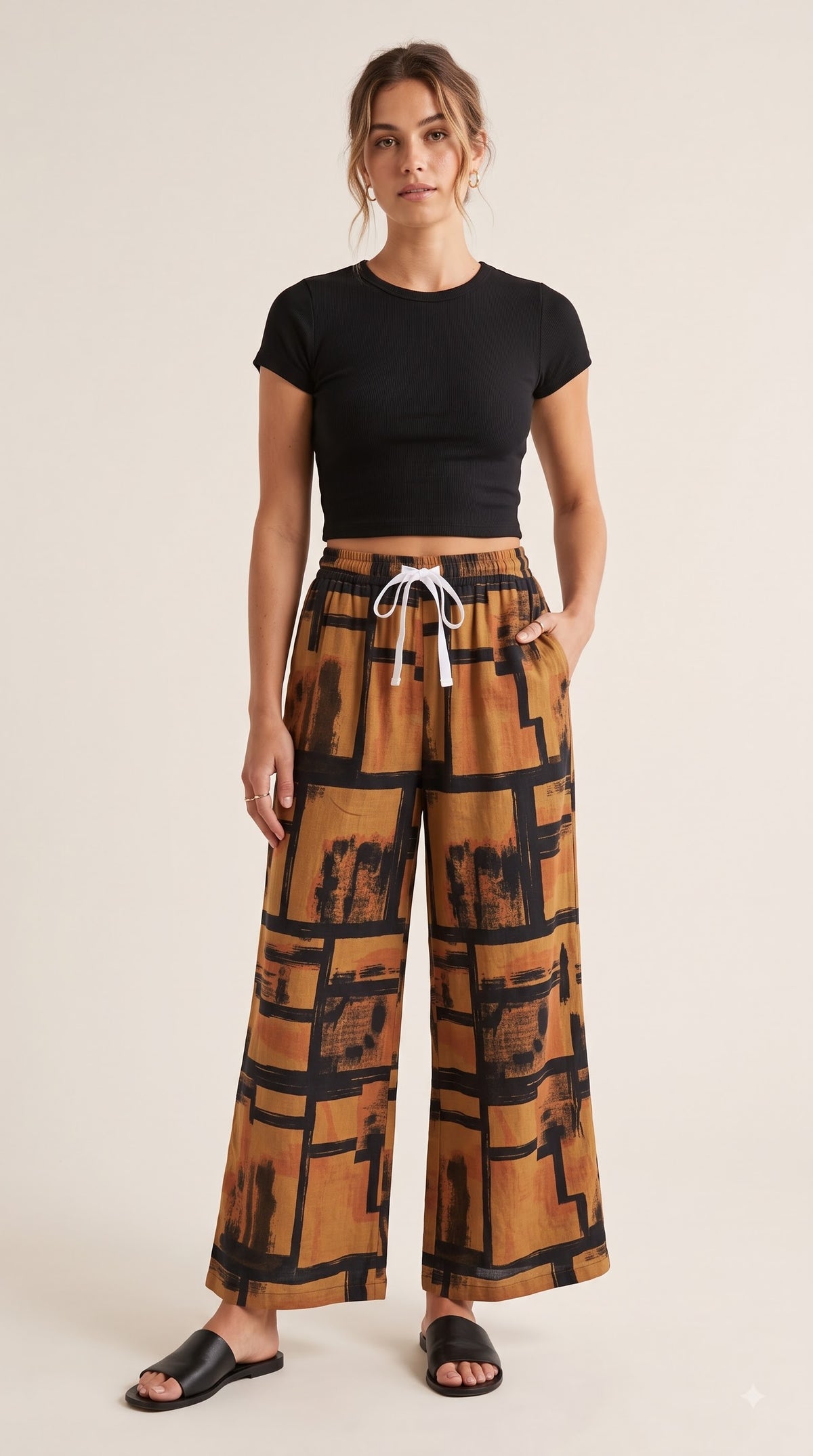 Brown and black abstract print palazzo pants – front view on model | TIGIQ