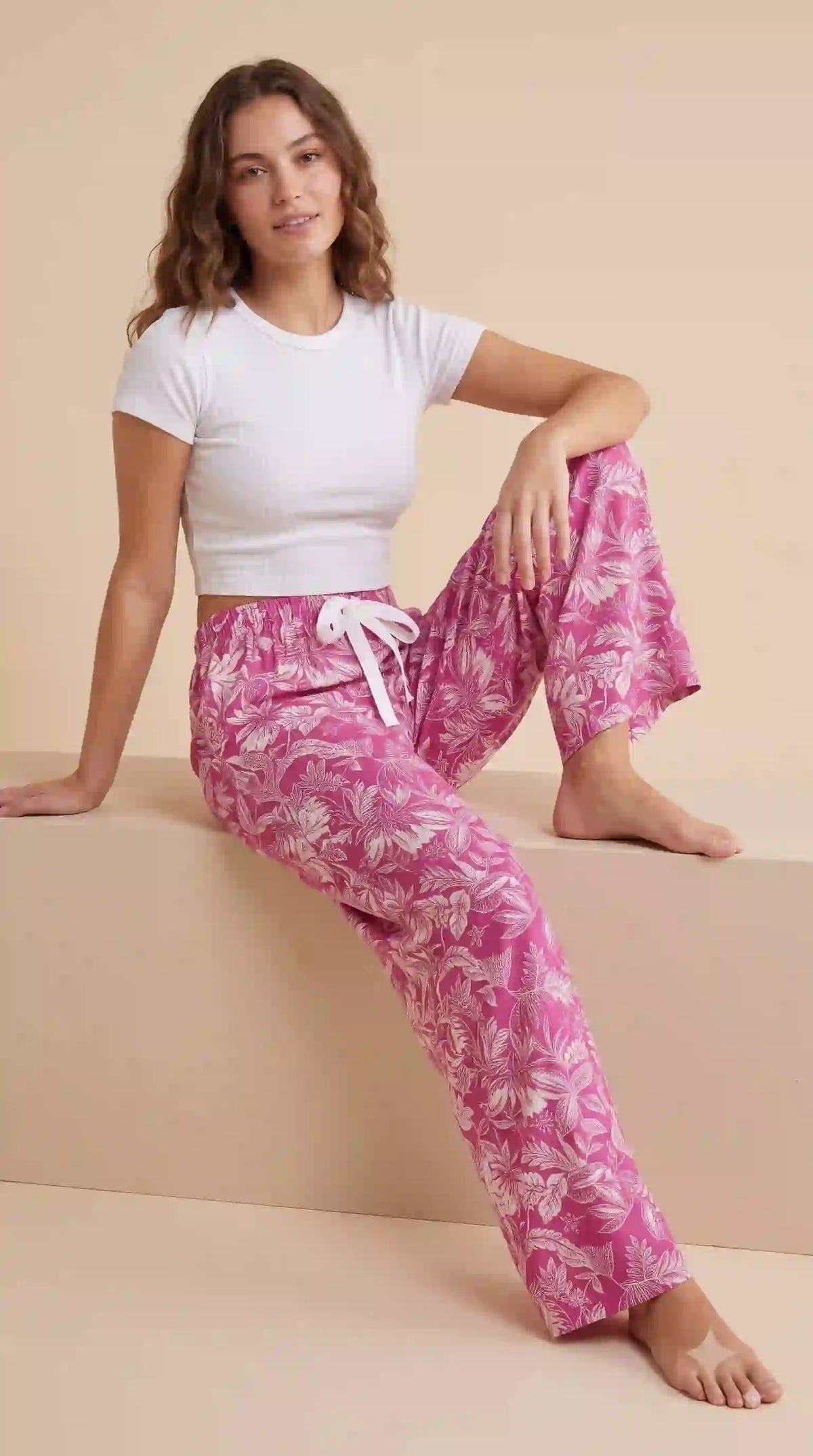 Pink floral Korean palazzo pants – seated pose | TIGIQ