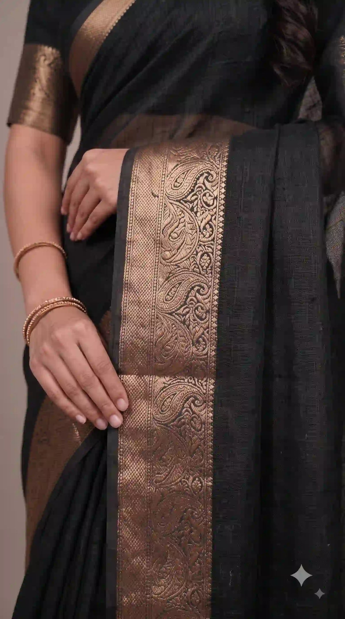 Gold zari border on black saree – close-up