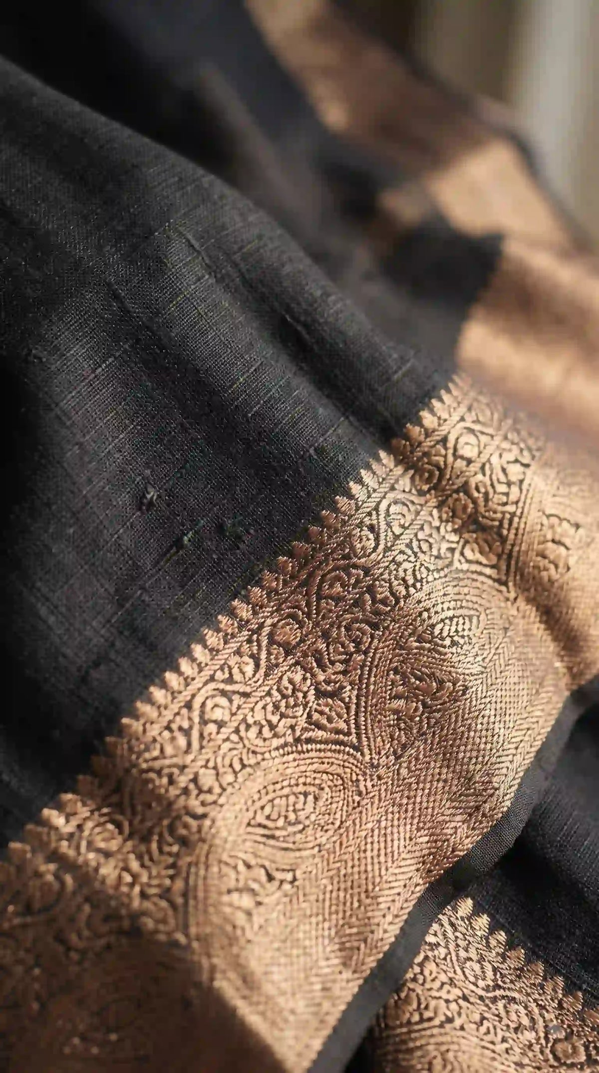 Zari weaving detail on black marshmallow saree