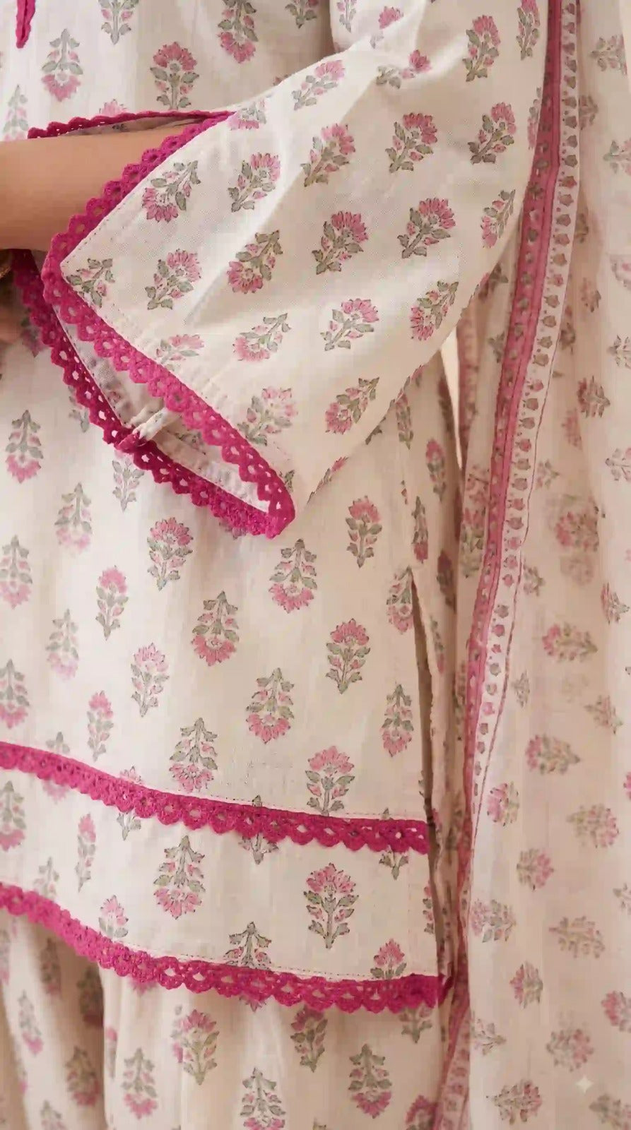 Fancy lace sleeve on white floral crepe top – close-up
